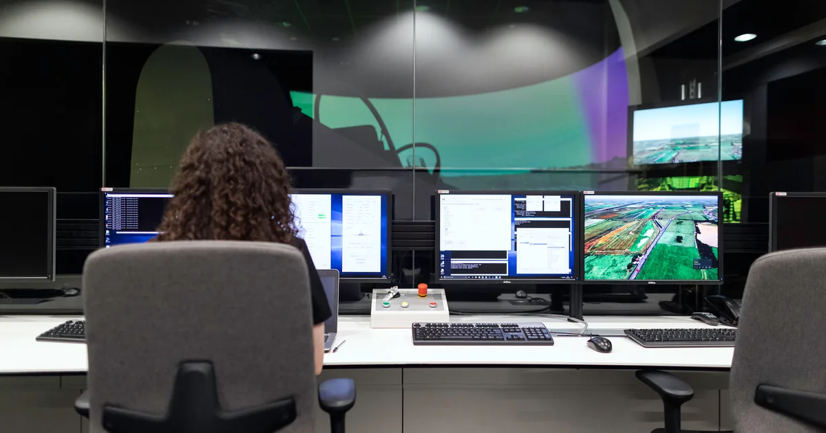 An engineer watching a wall of monitors in a control room, the supervising posture most agentic AI use cases still require