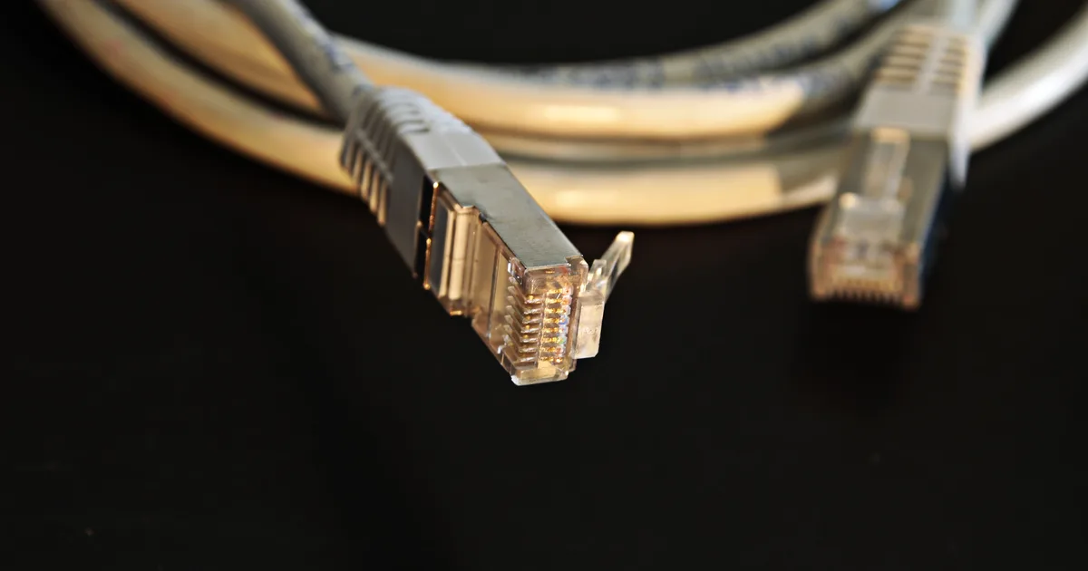 Close-up of an ethernet cable connector on a dark background, a visual stand-in for the connection an AI API opens between your code and a hosted model