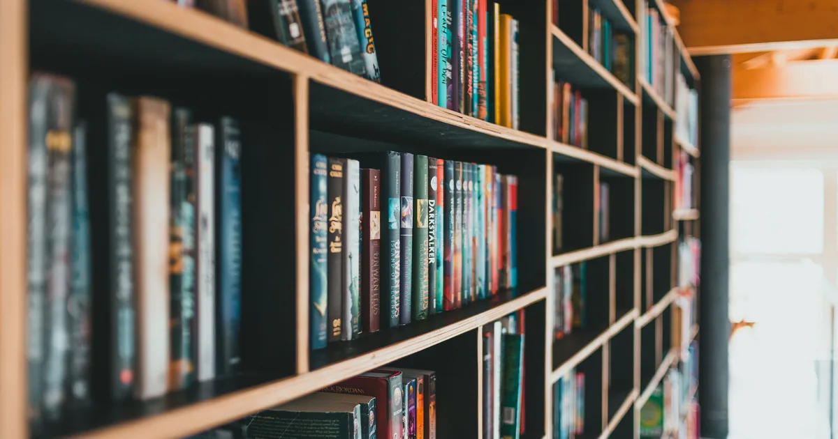 Shelves of books in a bright library, standing in for a roundup of the best books on AI agents in 2026