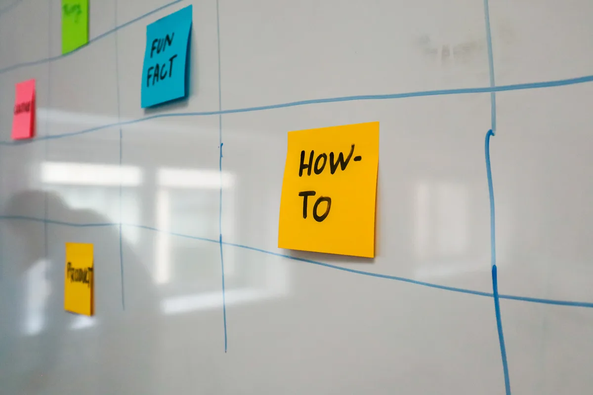 A whiteboard of colour-coded sticky notes, the filing discipline a cause and effect prompt library needs