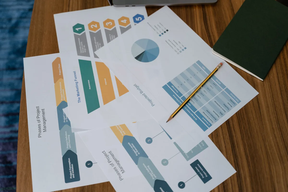 Printed charts and reports spread across a desk, the AI search visibility metrics and KPIs worth tracking