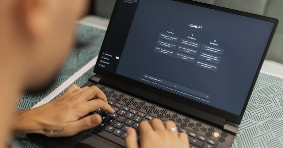 Person typing a question into the ChatGPT interface on a laptop, the app that runs on an LLM