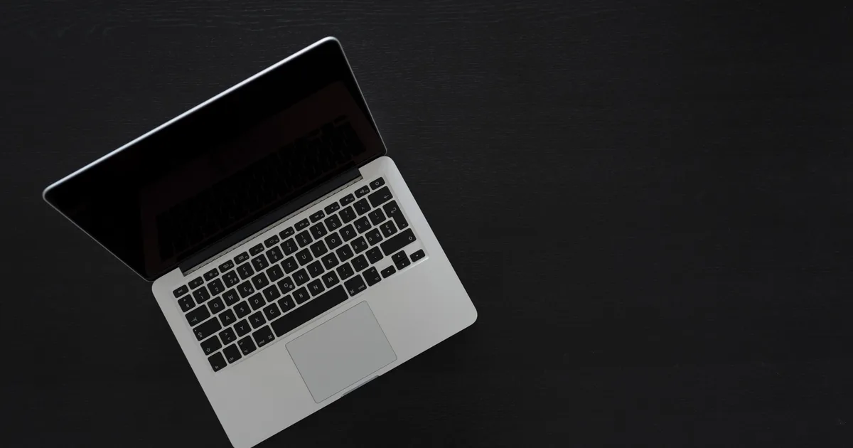 Overhead view of a MacBook on a dark desk, the kind of Apple Silicon laptop where an LLM uses unified memory