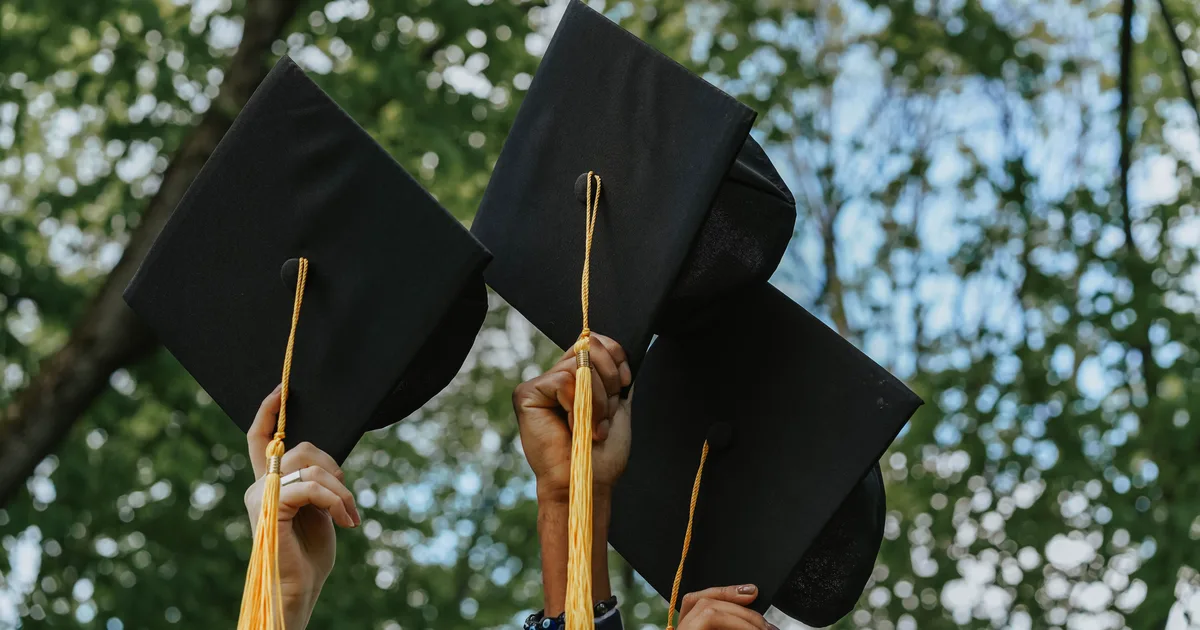 Hands holding graduation caps, the LLM degree that shares its acronym with the large language model