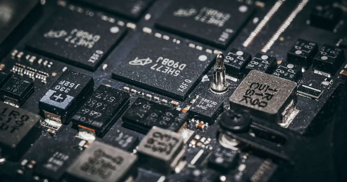 Close-up of microchips on a circuit board, the physical form of the AI engines NVIDIA designs and other companies build