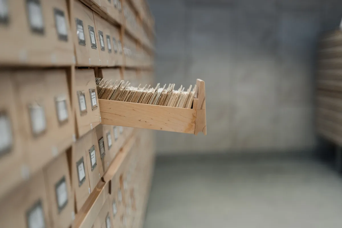 A vintage wooden card catalogue in a library archive, the filing discipline an AI prompt library needs to stay useful