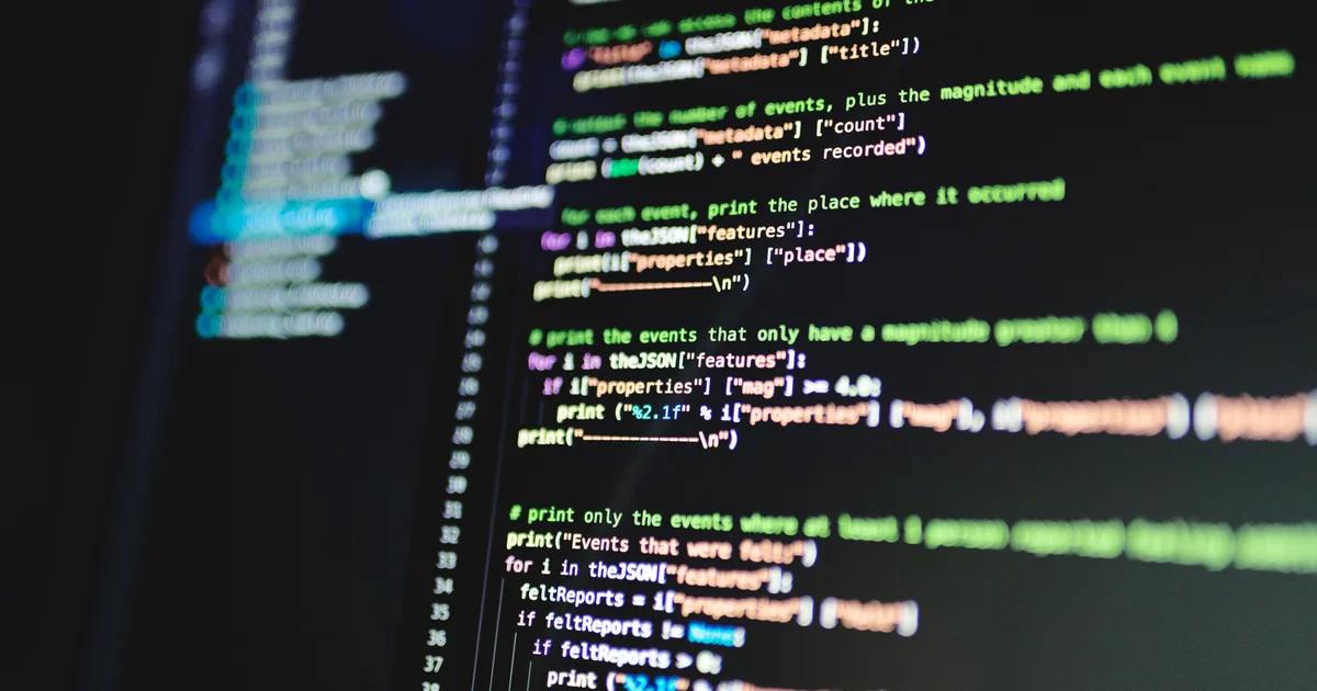Lines of colourful code on a dark monitor, the kind of project a text editor AI agent reads and edits