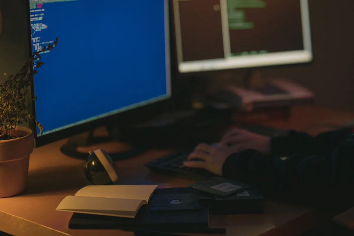A developer working at night on dual monitors, writing code to train a language model