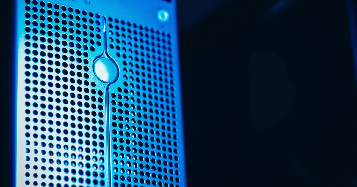 A modern server rack lit blue in a data center, evoking the compute it takes to build an LLM
